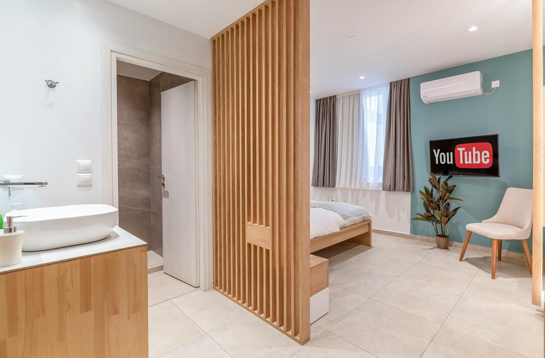 Studio Four, teal wall and oak slats